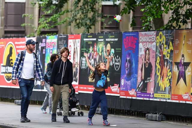 Members of the public walk past posters advertising shows ahead of the Edinburgh Festival Fringe. Picture: Jeff J Mitchell/Getty Images