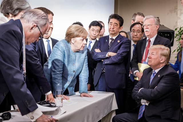 Angela Merkel deliberates with US President Donald Trump on the sidelines of a G7 summit in 2018 (Picture: Jesco Denzel/Bundesregierung via Getty Images)