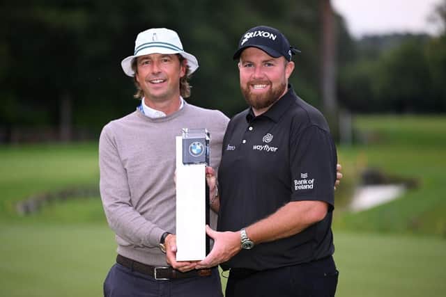 Shane Lowry shows off the  BMW PGA Championship trophy alongside his coach Neil Manchip, who is out with him in the Bahamas this week. Picture: Ross Kinnaird/Getty Images.