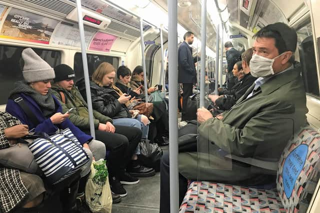 A man on the London Underground tube network wearing a protective facemask. Photo: PA Wire