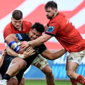 Munster's Jack Crowley, Jack O'Donoghue and Diarmuid Barron tackle Sione Vailanu of Glasgow.