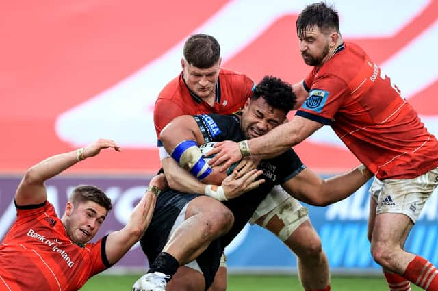 Munster's Jack Crowley, Jack O'Donoghue and Diarmuid Barron tackle Sione Vailanu of Glasgow.