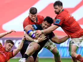 Munster's Jack Crowley, Jack O'Donoghue and Diarmuid Barron tackle Sione Vailanu of Glasgow.