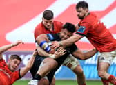 Munster's Jack Crowley, Jack O'Donoghue and Diarmuid Barron tackle Sione Vailanu of Glasgow.