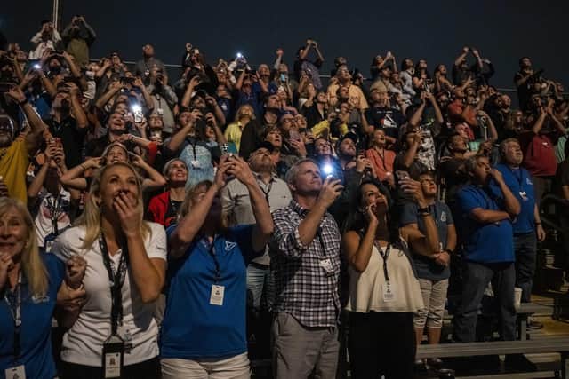 Guests at the Banana Creek viewing site watch the launch of NASAs Space Launch System rocket carrying the Orion spacecraft on the Artemis I flight test on November 16, 2022, at the Kennedy Space Center, Florida.  (Photo by Keegan Barber/NASA via Getty Images)