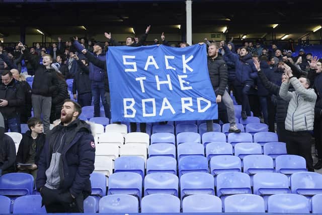 Fans protest against the Everton board after the English Premier League soccer match between Everton and Aston Villa at the Goodison Park stadium, in Liverpool, England, Saturday Jan. 22, 2022. (AP Photo/Jon Super)