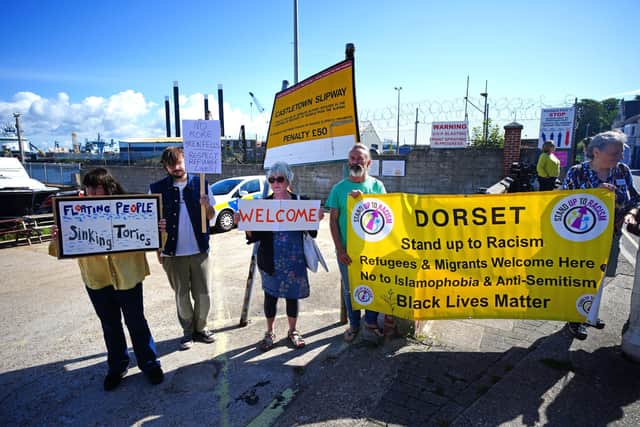 Protestors outside Portland Port in Dorset before the first asylum seekers arrive to board the Bibby Stockholm accommodation barge.