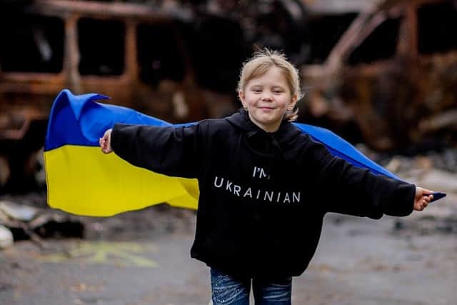 Tatyana, six, with a Ukrainian flag.