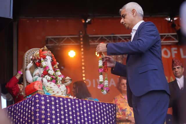 Mayor of London Sadiq Khan places a garland on a statue of the Hindu God Ganesh during the Diwali on the Square celebration, in Trafalgar Square, London.