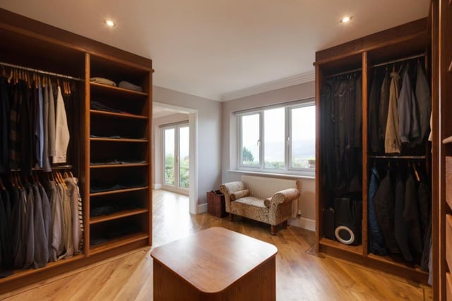 The master dressing room is fitted with open furniture incorporating short/long hanging, shelving and drawers.