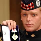 Corporal Shaun Jardine of the King's Own Scottish Borderers holds his conspicuous gallantry cross , after it was presented to him by the Queen, at Buckingham Palace in October 2004. Jardine recieved his medal after  storming two Iraq gun positions single handed while under fire. (Photo:John Stillwell.WPA Pool).