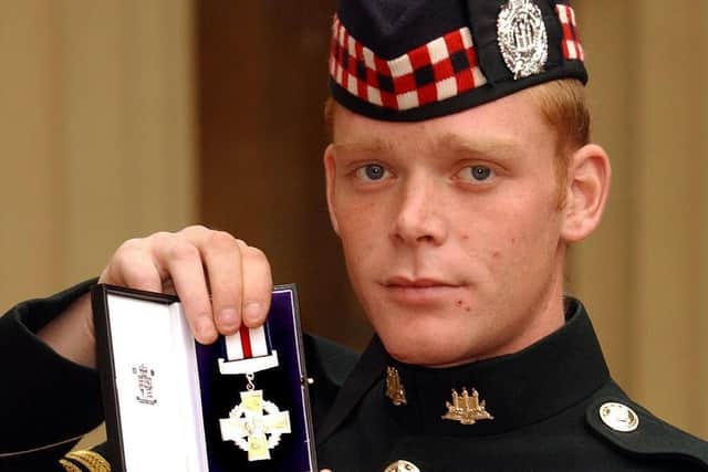 Corporal Shaun Jardine of the King's Own Scottish Borderers holds his conspicuous gallantry cross , after it was presented to him by the Queen, at Buckingham Palace in October 2004. Jardine recieved his medal after  storming two Iraq gun positions single handed while under fire. (Photo:John Stillwell.WPA Pool).