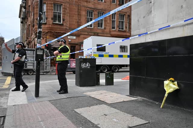 A bouquet of flowers are left close to the scene where a man was shot dead after a multiple stabbing in a central Glasgow hotel. (Photo by Jeff J Mitchell/Getty Images)