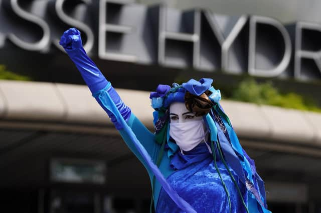 Extinction Rebellion Scotland's Blue Rebels perform outside the SEC in Glasgow, where the global climate change conference Cop26 will take place in November.