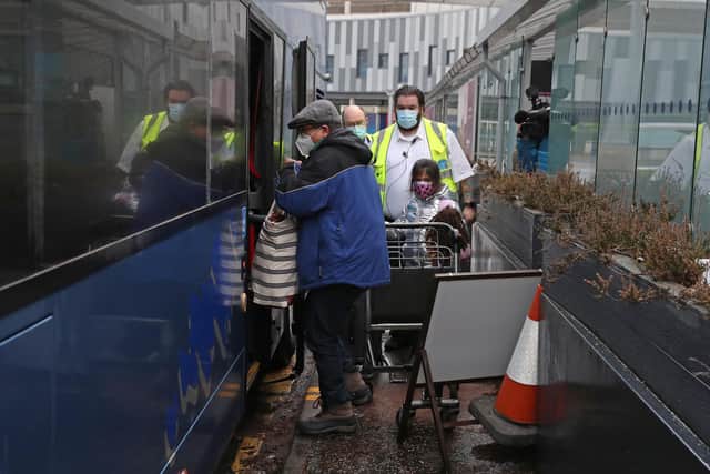 Chun Wong and his daughter Kiernan, 8, leave Edinburgh airport after entering the country on the first day that travellers flying directly into Scotland on international flights have to self-isolate for 10 days in a quarantine hotel room.