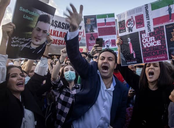 A protester tears up his Iranian passport during a protest against Iran and the death of Iranian Mahsa Amini  in Istanbul, Turkey.