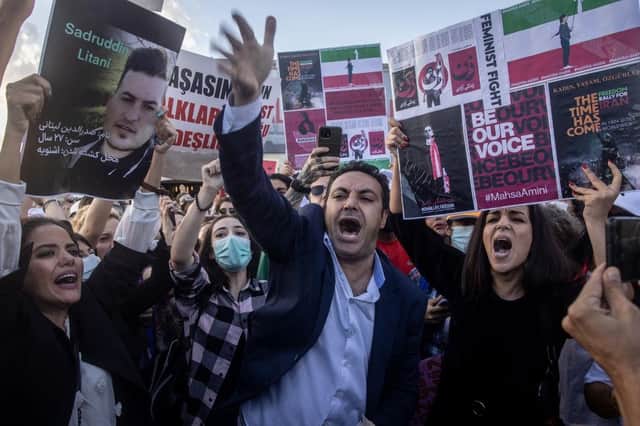 A protester tears up his Iranian passport during a protest against Iran and the death of Iranian Mahsa Amini in Istanbul, Turkey.