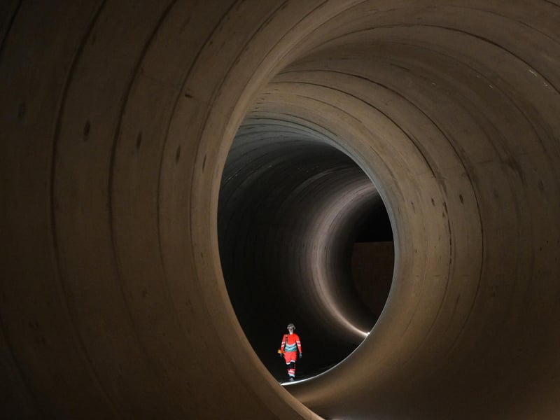 A civil engineer walks inside a 7 metre concrete tunnel at the Thames Tideway building site, in west London. London's existing sewerage network dates back to the second half of the 1800s. With the size of the population set to continue to swell