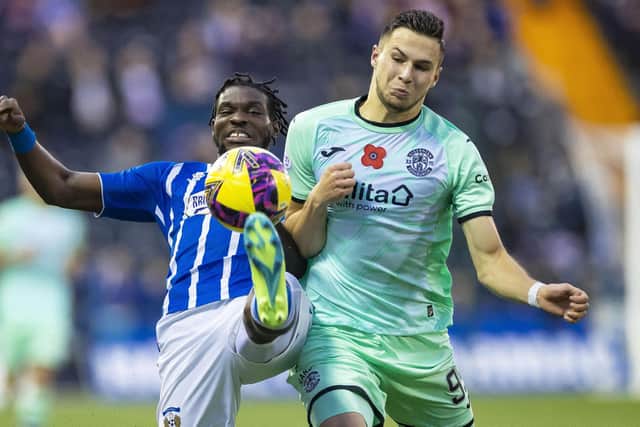 Kilmarnock's Jeriel Dorsett (L) and Hibs' Mykola Kukharevych (R) during a cinch Premiership match between Kilmarnock and Hibernian at Rugby Park, on November 12, 2022, in Kilmarnock, Scotland. (Photo by Roddy Scott / SNS Group)