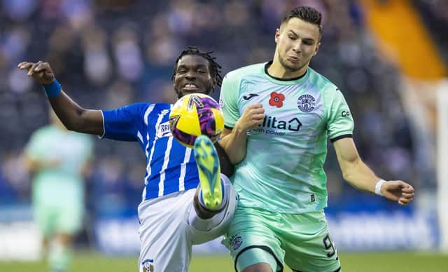 Kilmarnock's Jeriel Dorsett (L) and Hibs' Mykola Kukharevych (R) during a cinch Premiership match between Kilmarnock and Hibernian at Rugby Park, on November 12, 2022, in Kilmarnock, Scotland. (Photo by Roddy Scott / SNS Group)