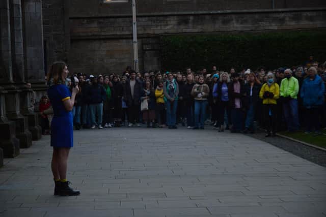 Darya Tsymbalyuk, dressed in the colours of the Ukrainian flag, addresses students at a vigil in support of Ukraine in St Andrews on Monday.