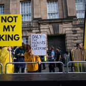 Protesters holding signs reading 'Not my King' are seen outside St Giles' Cathedral in Edinburgh. Picture: Peter Summers/Getty Images