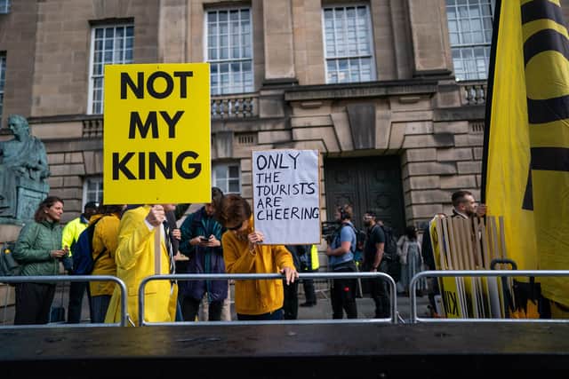 Protesters holding signs reading 'Not my King' are seen outside St Giles' Cathedral in Edinburgh. Picture: Peter Summers/Getty Images