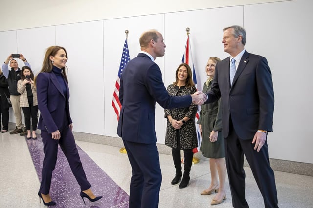 William and Kate are greeted by Massachusetts Gov. Charlie Baker, right, and first lady Lauren Baker, second right, as they arrive at Boston Logan International Airport.