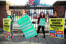 Students hold up Sinn Fein anti-Brexit placards during a rally against Brexit and any hard border between Ireland and Northern Ireland outside Queens University Belfast. Picture: Paul Faith/AFP via Getty Images