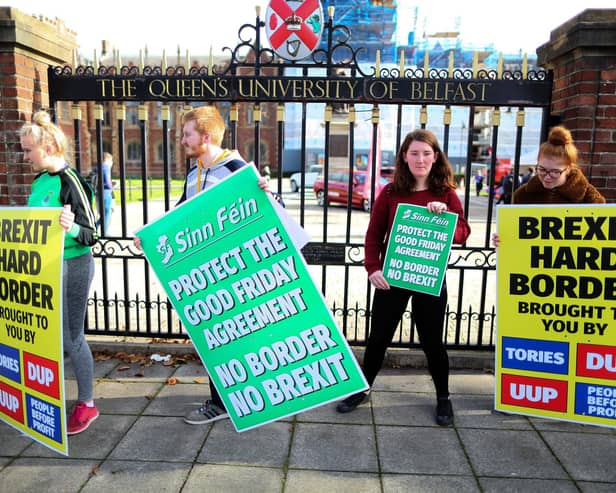 Students hold up Sinn Fein anti-Brexit placards during a rally against Brexit and any hard border between Ireland and Northern Ireland outside Queens University Belfast. Picture: Paul Faith/AFP via Getty Images
