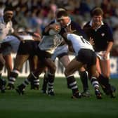 Chris Gray (centre high) of Scotland shrugs off a tackle during the match against Fiji at Murrayfield in October 1989. Scotland won the match 38-17. Pic: Russell Cheyne/Allsport