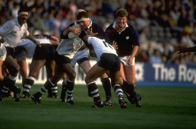 Chris Gray (centre high) of Scotland shrugs off a tackle during the match against Fiji at Murrayfield in October 1989. Scotland won the match 38-17. Pic: Russell Cheyne/Allsport