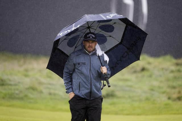 Richie Ramsay shelters under his umbrella during a wet final round in the 151st Open at Royal Liverpool. Picture: Tom Russo/The Scotsman.