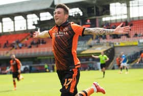 Jamie Robson celebrates after scoring the only goal of the game for Dundee United against Rangers at Tannadice. (Photo by Ross Parker / SNS Group)