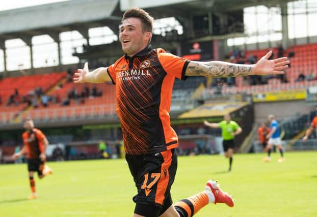 Jamie Robson celebrates after scoring the only goal of the game for Dundee United against Rangers at Tannadice. (Photo by Ross Parker / SNS Group)