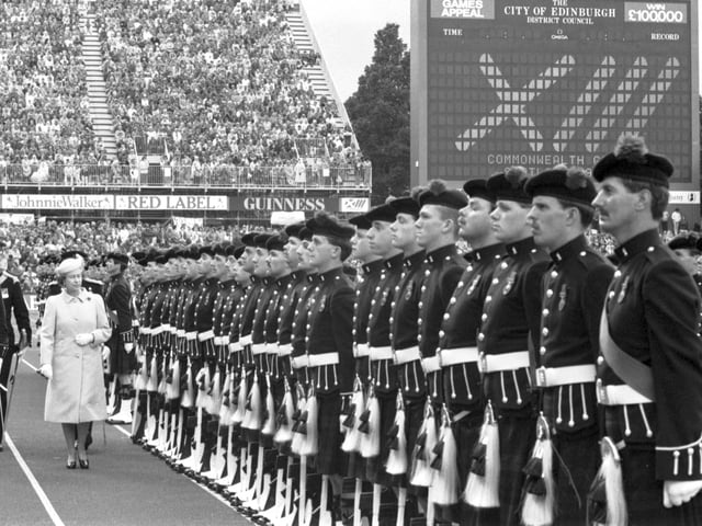 Queen Elizabeth II reviews her guard of honour at the closing ceremony of the Edinburgh Commonwealth Games 1986.