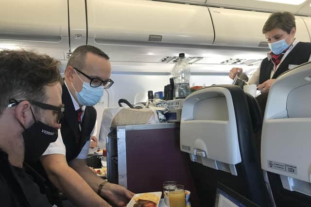 Staff serving food on the first BA holiday flight back to Lisbon.