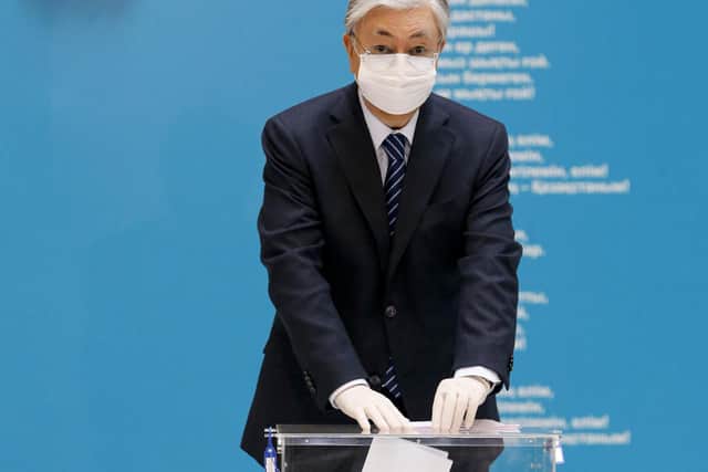 Kazakhstan's President Kassym-Jomart Tokayev, wearing a face mask and gloves because of the Covid pandemic, casts his ballot at a polling station during a parliamentary elections in the capital city, Nur-Sultan, on Sunday (Picture: AP)