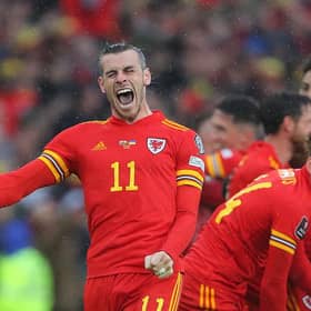 Wales' striker Gareth Bale (L) celebrates with teammates after winning the FIFA World Cup 2022 play-off final against Ukraine. (Photo by GEOFF CADDICK/AFP via Getty Images)