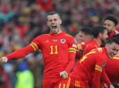 Wales' striker Gareth Bale (L) celebrates with teammates after winning the FIFA World Cup 2022 play-off final against Ukraine. (Photo by GEOFF CADDICK/AFP via Getty Images)