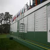 The scoreboard is updated with a "weather warning" and "play suspended" sign during the first round of the Masters at Augusta National Golf Club. Picture: Rob Carr/Getty Images