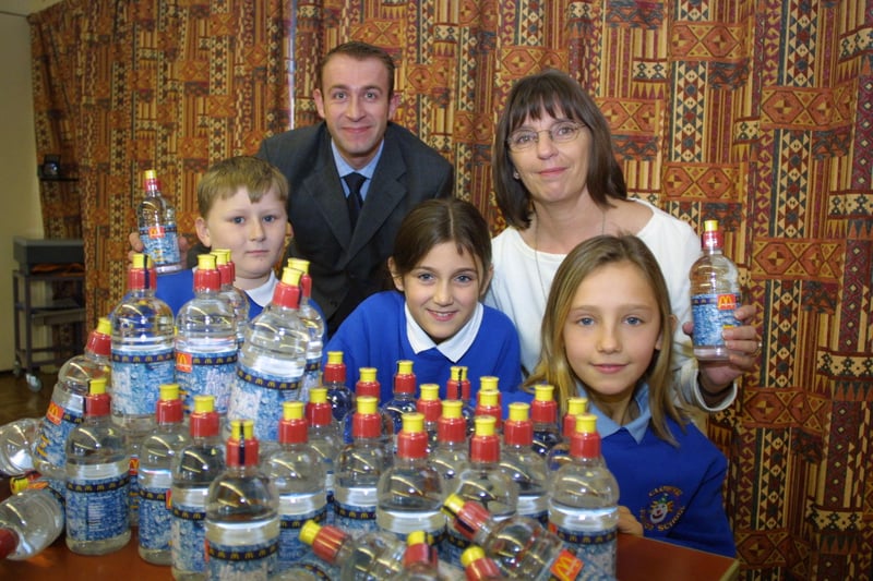 Children seen posing with bottled water.