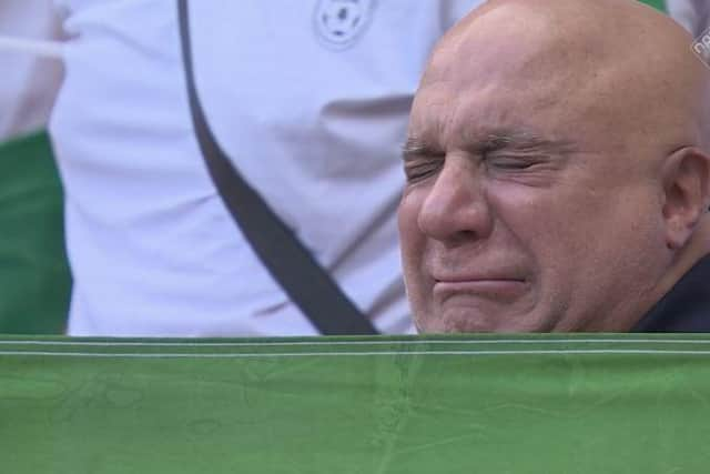 A man openly weeps during the Iran anthem in the Ahmad Bin Ali Stadium, Al-Rayyan