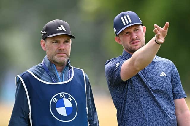 Connor Syme talks tactics with his caddie Ryan McGuigan on day two of the BMW International Open in Munich. Picture: Stuart Franklin/Getty Images.