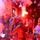 A Napoli fan cannot hide his emotion at the Largo Maradona in the Quartieri Spagnoli district of Naples following his team's Scudetto triumph.