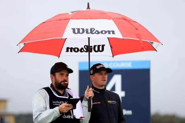 David Law talks tactics with caddie Max Bill on the fourth tee at St Andrews during day one of the Alfred Dunhill Links Championship. Picture: Stephen Pond/Getty Images.