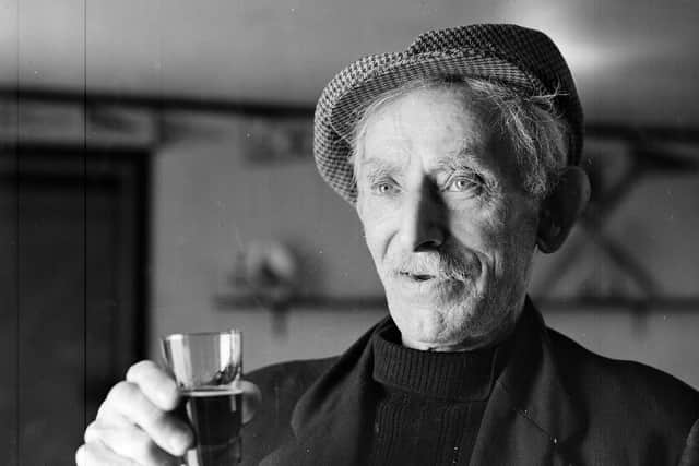 South Uist man John MacIsaac with a glass of Highland Nectar whisky, bottles of which he liberated from the SS Politician  when she went aground in 1941.