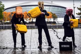 Activists from campaign group Ocean Rebellion pour fake oil in front of the COP26 venue in Glasgow, ahead of the start of the global climate summit. Picture: Andy Buchanan/Getty Images