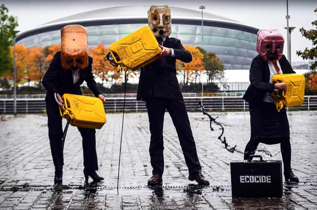 Activists from campaign group Ocean Rebellion pour fake oil in front of the COP26 venue in Glasgow, ahead of the start of the global climate summit. Picture: Andy Buchanan/Getty Images