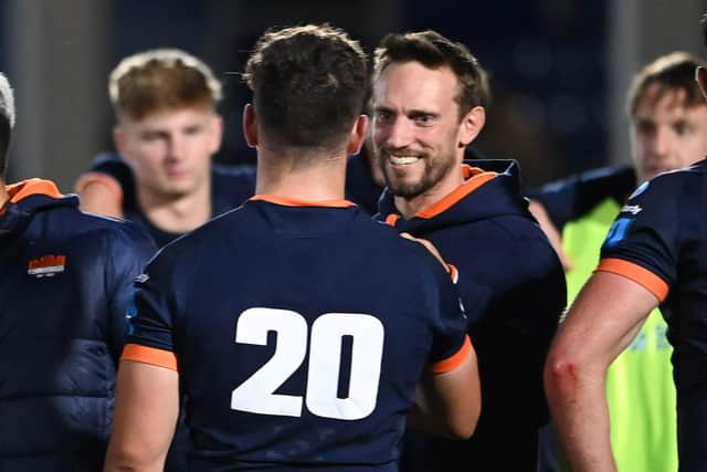 Edinburgh head coach Mike Blair is all smiles at full time as he congratulates Connor Boyle on the win over Scarlets. Picture: Paul Devlin/SNS